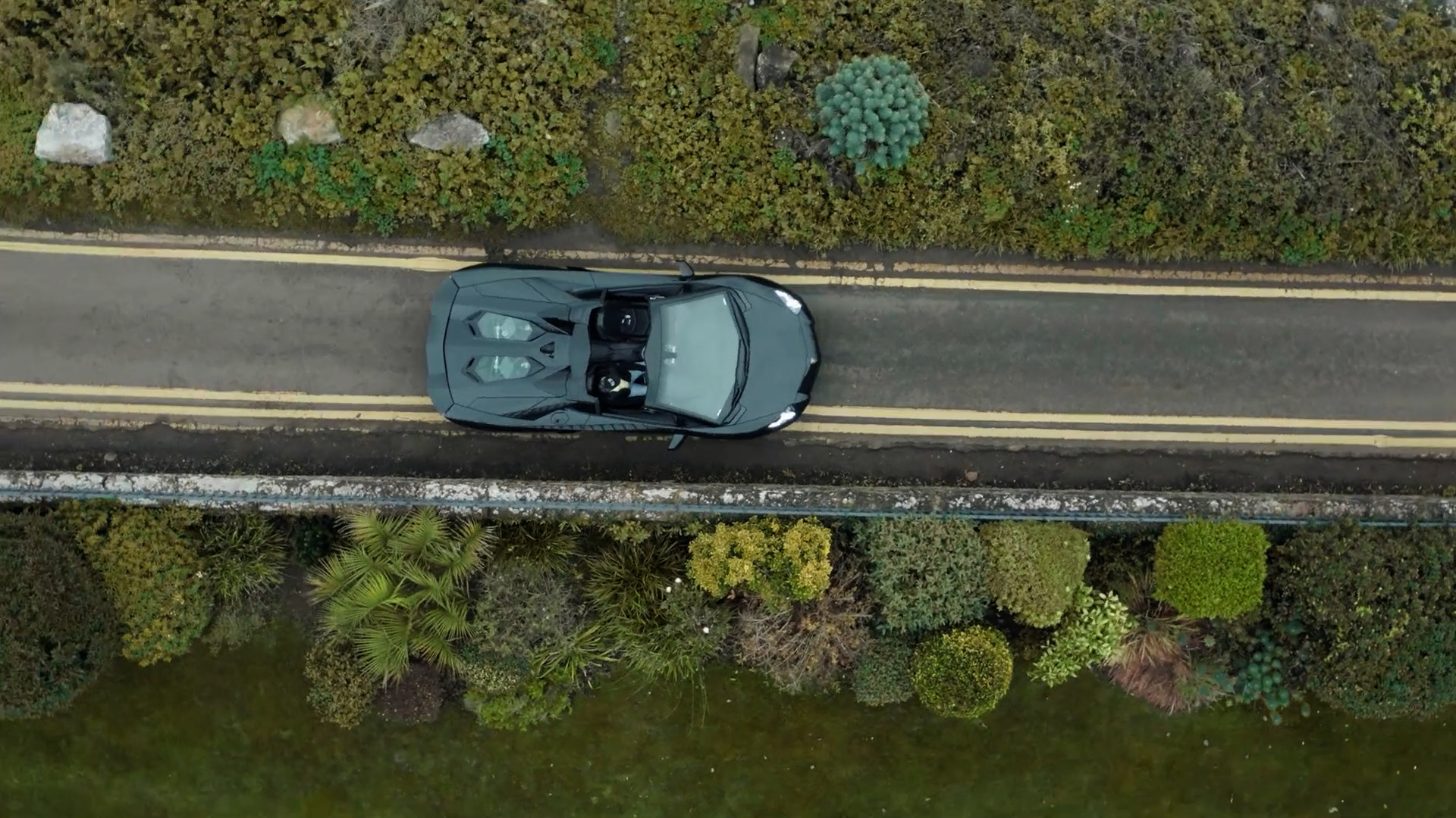 videography with drones used to create an overhead shot of a car driving